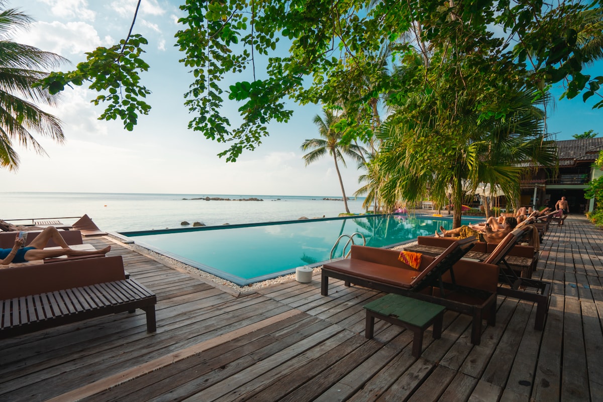 Pool deck framed by palms at Sunny Palace Ocho Bay
