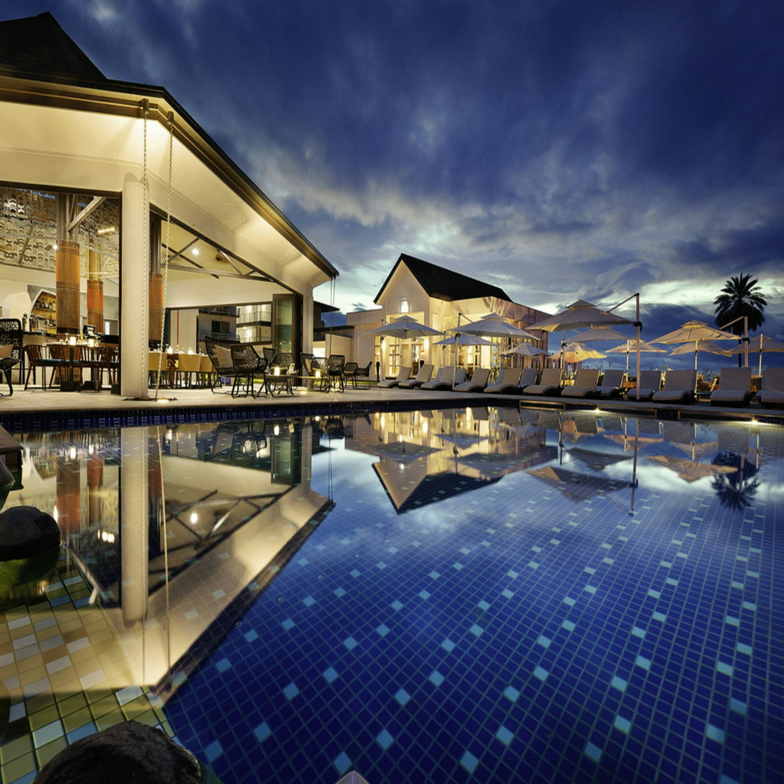Poolside restaurant at dusk set for a celebration